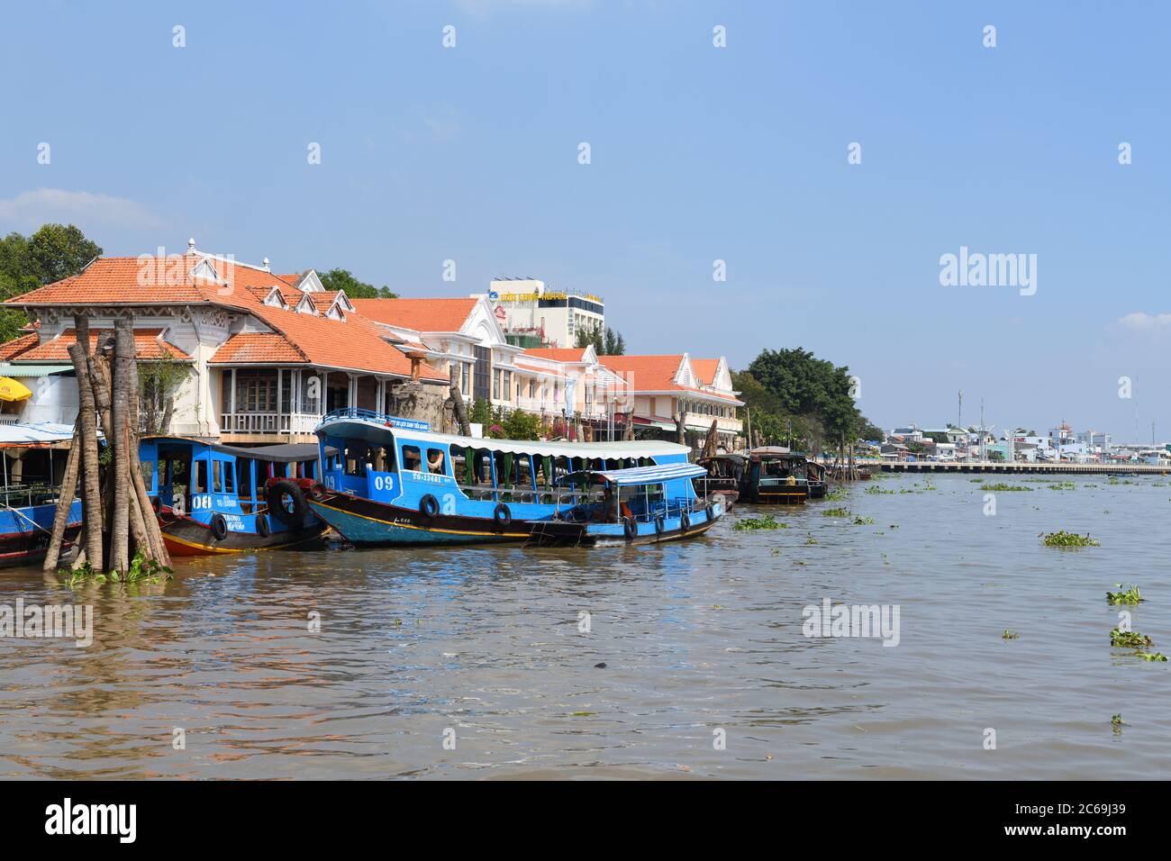 Motorised Junk boats ferrying passengers and visitors on the silt heavy Mekong river delta from My Tho in Vietnam, Asia Stock Photo