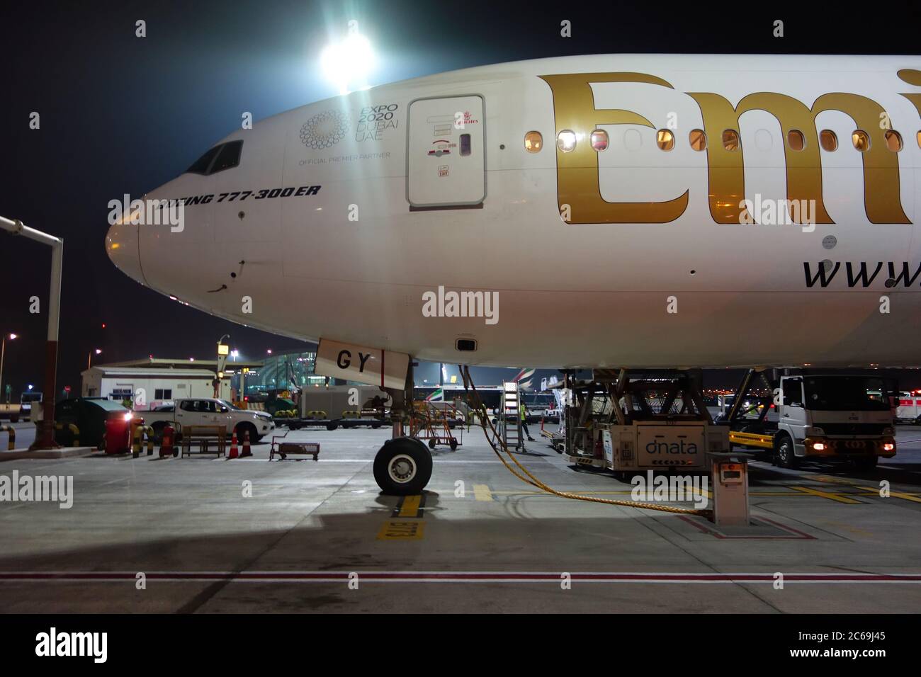 Emirates aircraft nose and wheel of Boeing 777 300 ER at its stance in Dubai International Airport, UAE Stock Photo