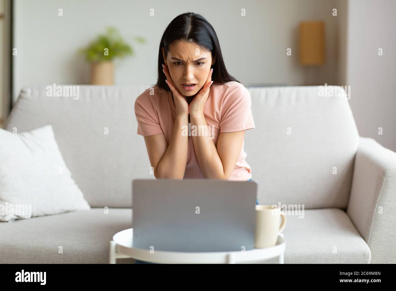 Shocked Woman At Laptop Having Bad Internet Connection At Home Stock Photo