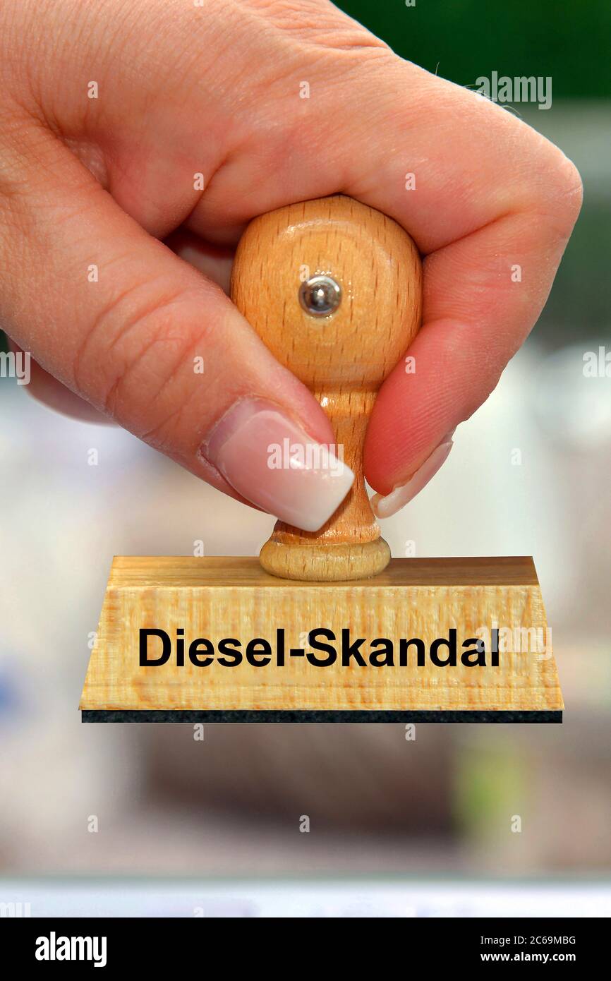 hand with stamp lettering Diesel-Skandal; Diesel scandal, Germany Stock Photo