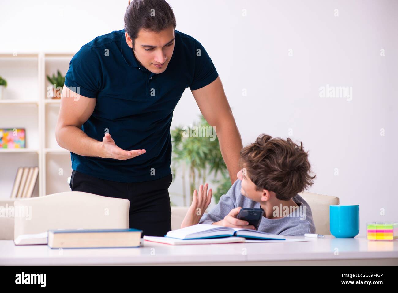 Father and son in the exam preparation concept Stock Photo - Alamy