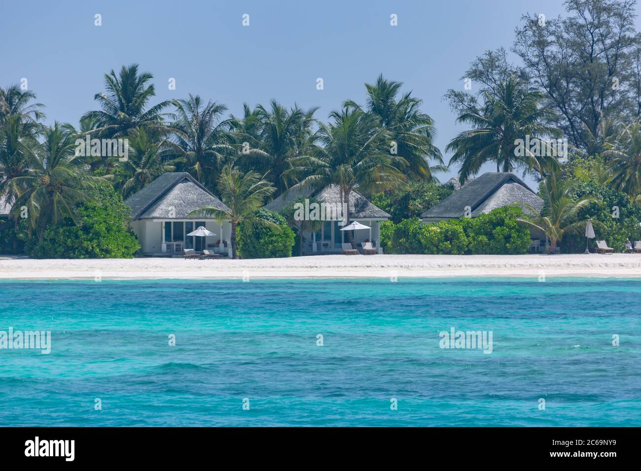 View of Luxury beach landscape with beach villas or bungalows with palm trees ...