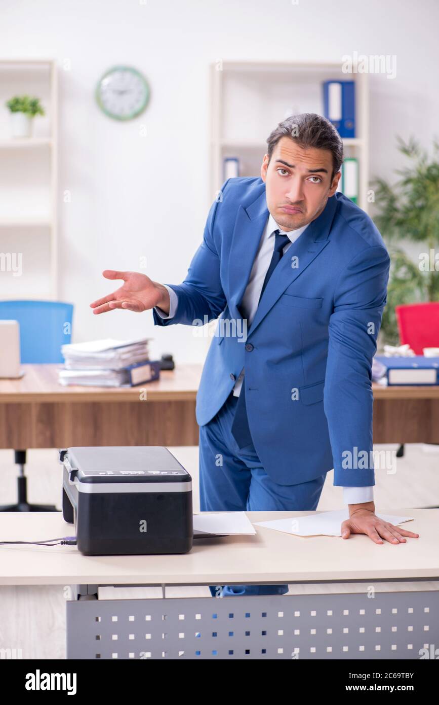 Working Copy Cop Young employee making copies at copying machine Stock Photo - Alamy