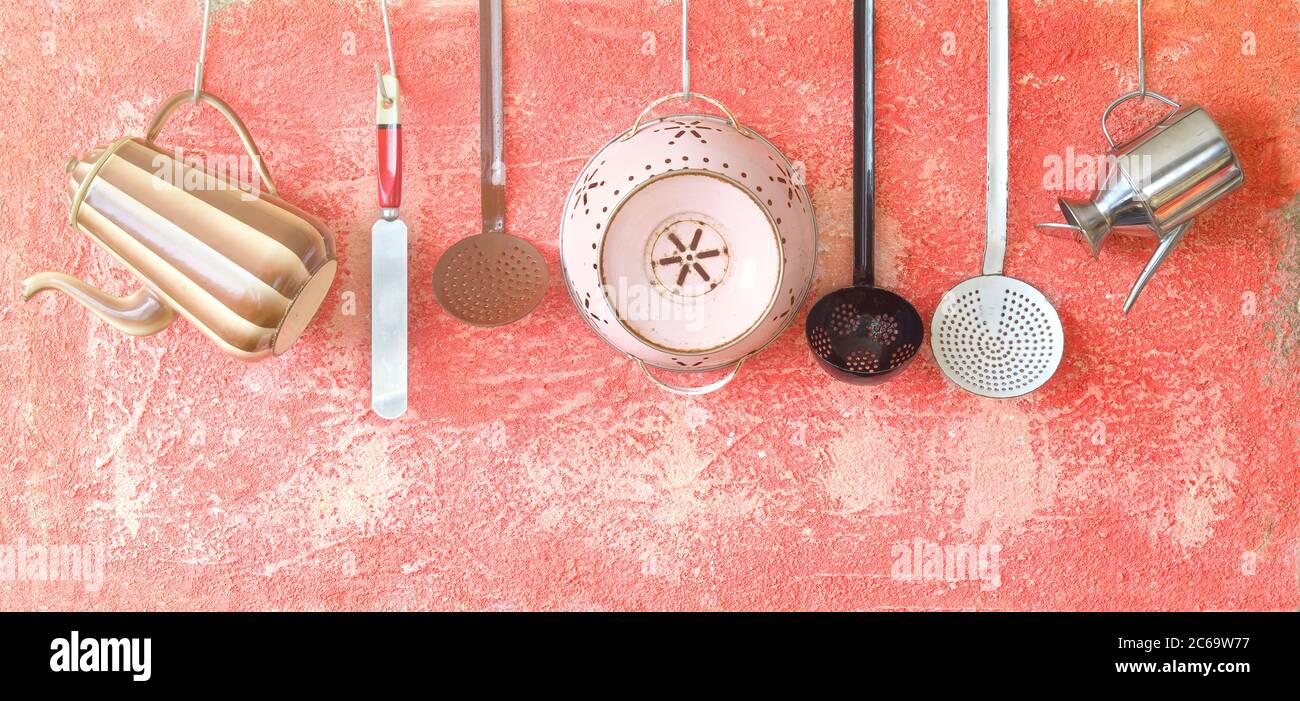 Various vintage kitchen utensils on a rustic wall, good copy space Stock Photo