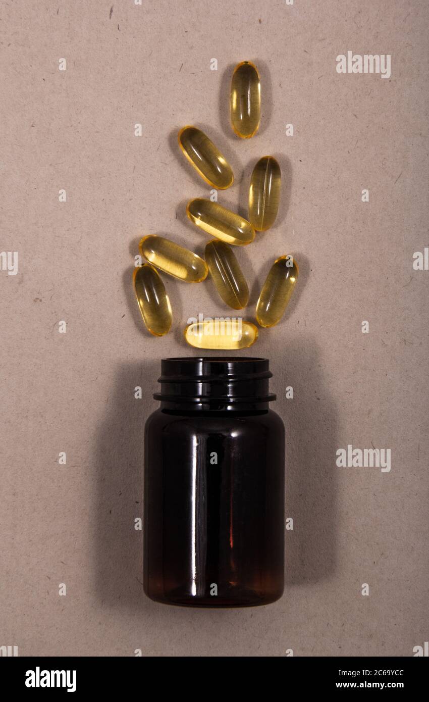 Color capsules out of cover. Color capsules with a simple background next to the dish or next to each other. Stock Photo