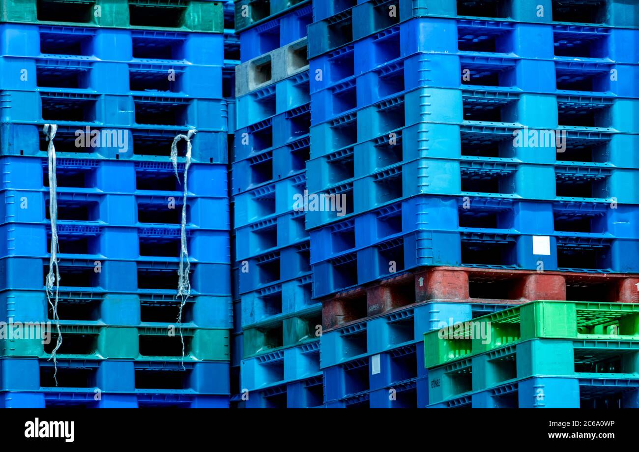 Pile of plastic shipping pallet. Industrial plastic pallet stacked at factory warehouse. Cargo