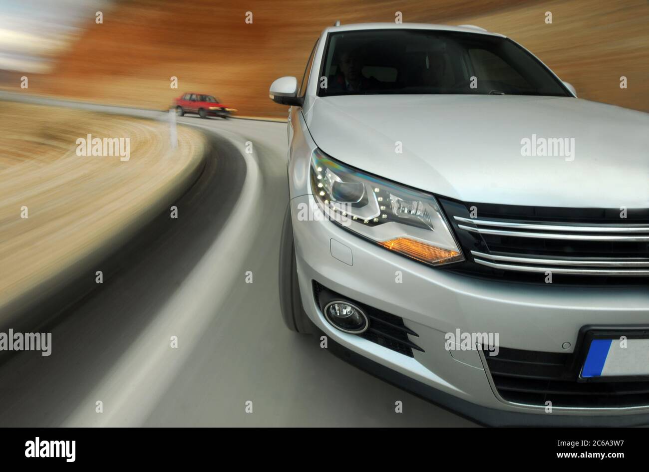 Dynamic driving an SUV in a curve Stock Photo - Alamy