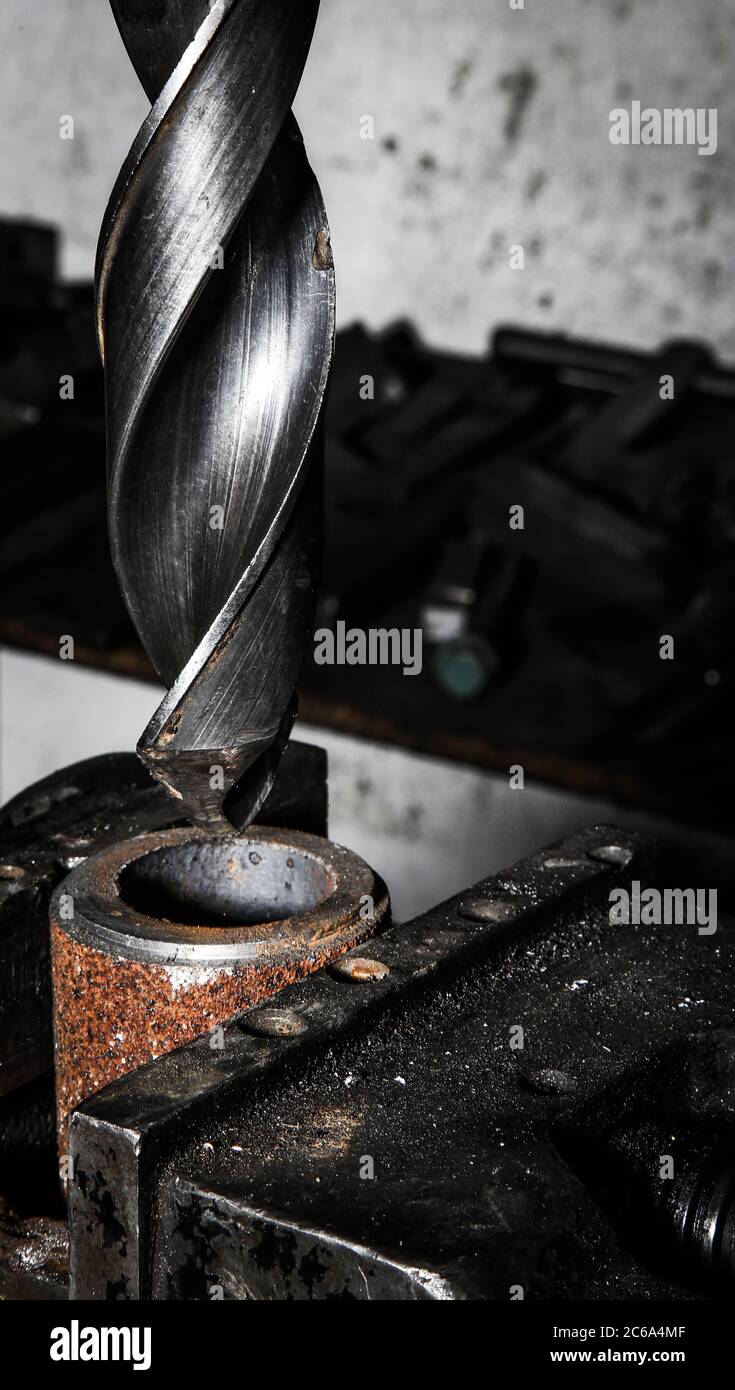 A drill for drilling holes with a black background Stock Photo
