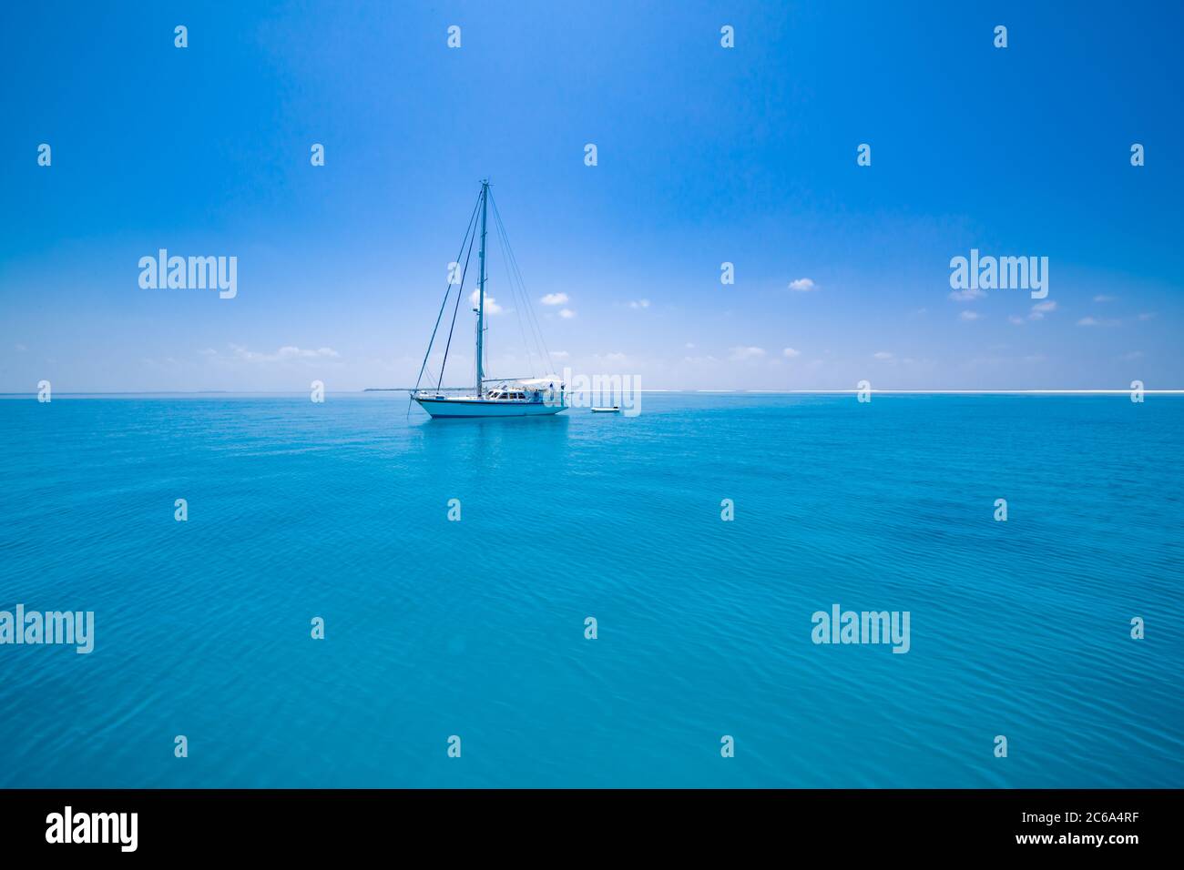 Beautiful bay with sailing boat. Summer recreational amazing view to yacht, swimming woman and clear water Stock Photo