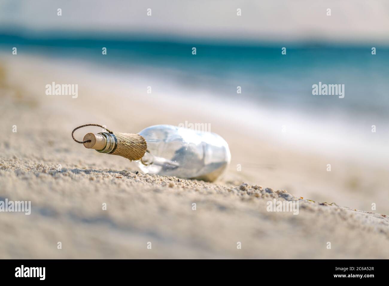 Bottle with a message, sea waves splashing on calm coast, shore. Exotic ...