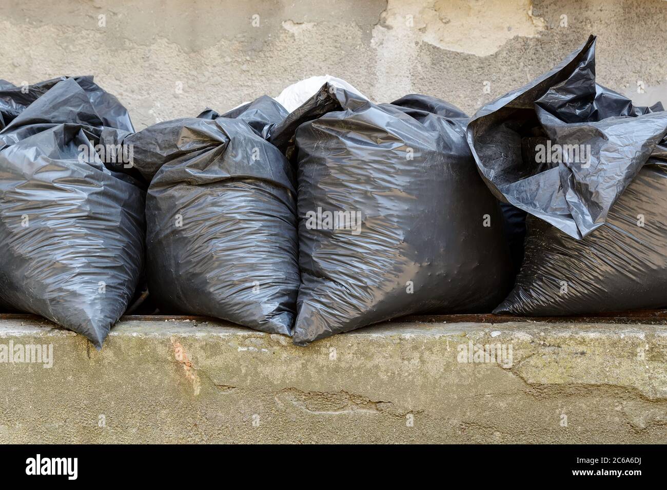 Four filled black bags with construction debris after apartment repair
