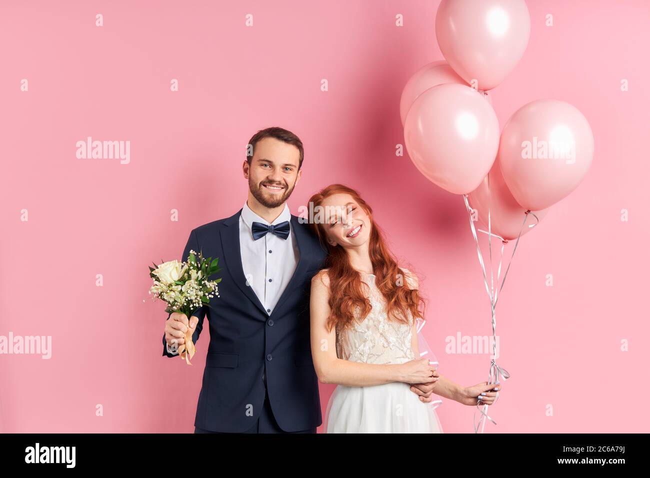 Portrait of beautiful man and woman wearing wedding dress and tuxedo ...