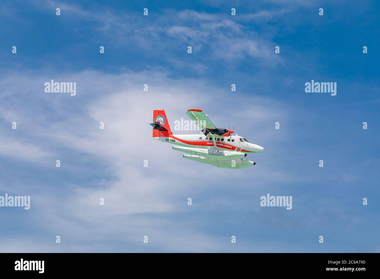 Male, Maldives - 12/17/2017: Seaplane of Trans Maldivian Airways airline is flying in blue sky over Male. Luxury travel, exotic holiday transportation Stock Photo