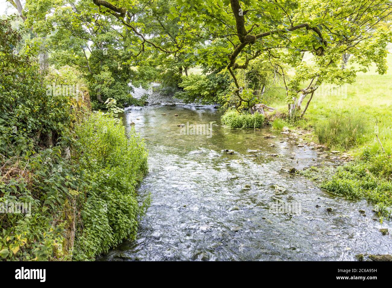 The River Dikler passing by the old mill in the Cotswold village of Upper Swell, Gloucestershire UK Stock Photo