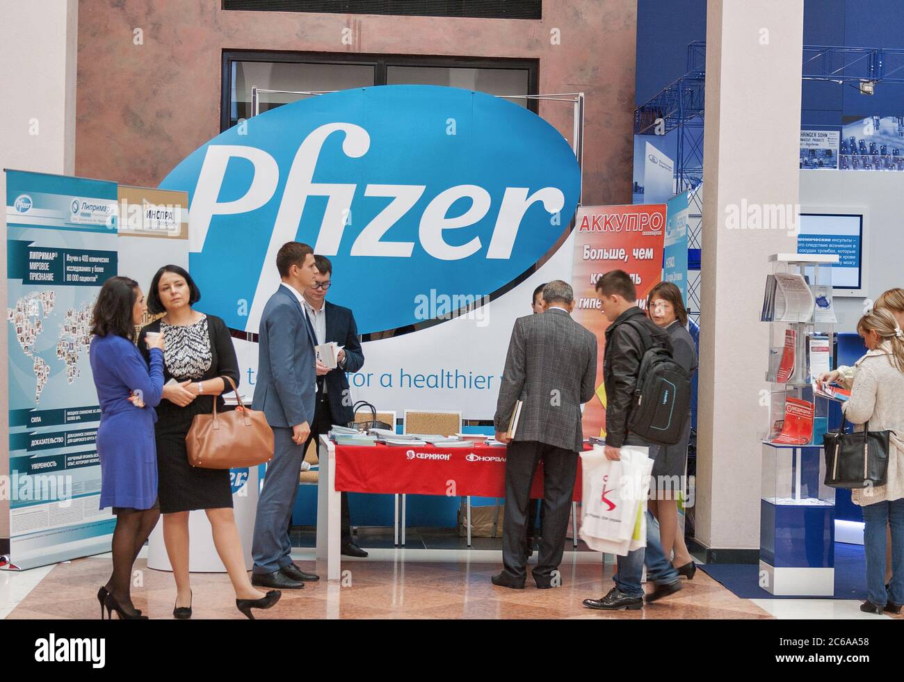 KYIV, UKRAINE - SEPTEMBER 23, 2014: People visit Pfizer American pharmaceutical company booth at XV National Congress of Cardiologists in Olimpiyskiy Stock Photo
