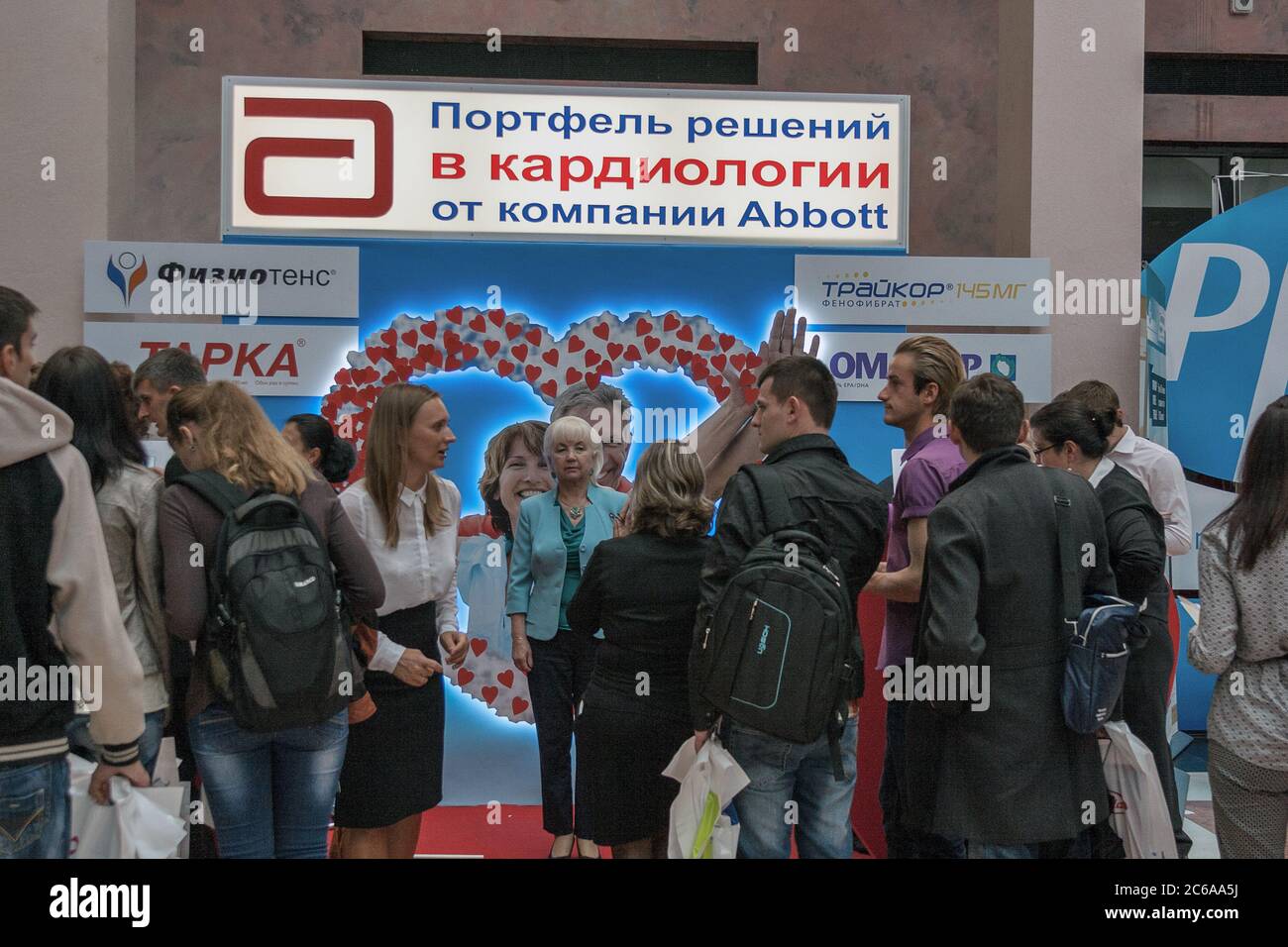 KYIV, UKRAINE - SEPTEMBER 23, 2014: People visit Abbott American pharmaceutical company booth at XV National Congress of Cardiologists in Olimpiyskiy Stock Photo