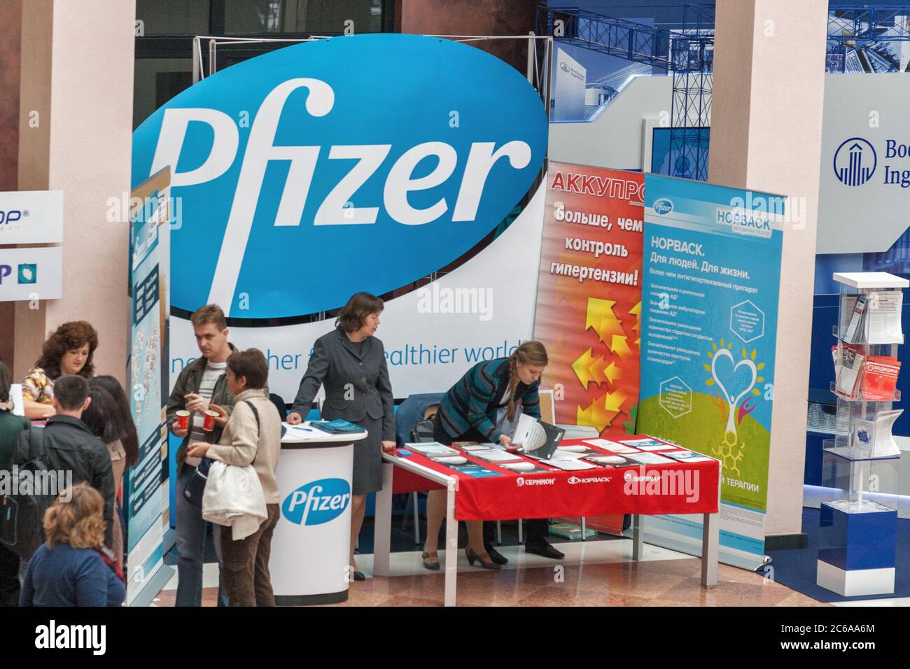 KYIV, UKRAINE - SEPTEMBER 24, 2014: People visit Pfizer American pharmaceutical company booth at XV National Congress of Cardiologists in Olympiyskiy Stock Photo