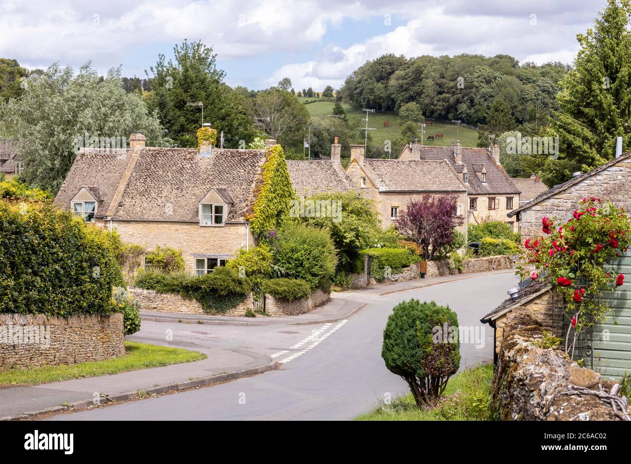 Old stone cottages in the Cotswold village of Naunton, Gloucestershire UK Stock Photo