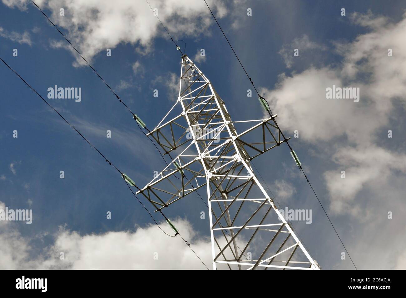 Power line mast against the blue sky. Stock Photo