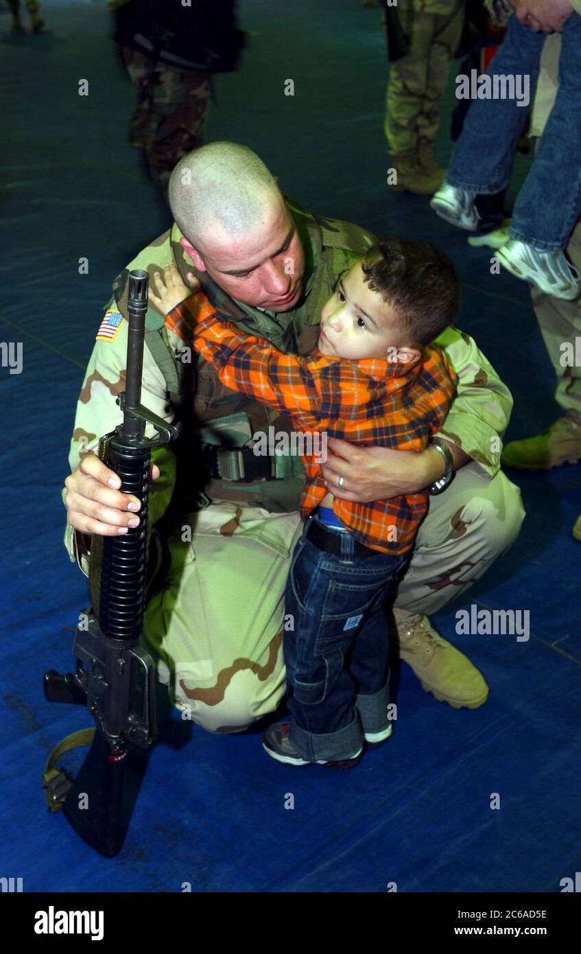 Fort Hood, Texas March 23 2003: Member of the  U.S. Army's III Corps 13th Corps Support Command (COSCOM) based at Fort Hood says goodbye to a young boy after his unit received deployment orders late Friday. The troops will provide logistical and medical support to fighting units based in the Persian Gulf.  ©Bob Daemmrich Stock Photo