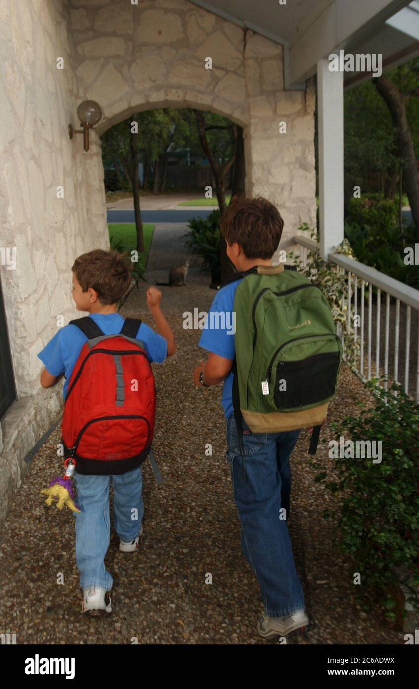 Austin, Texas August 19, 2003: The Daemmrich Boys, Chris (9) and Robin (6) head off on the first day of school.  Robin is in first grade and Chris is in fourth. ©Bob Daemmrich Stock Photo