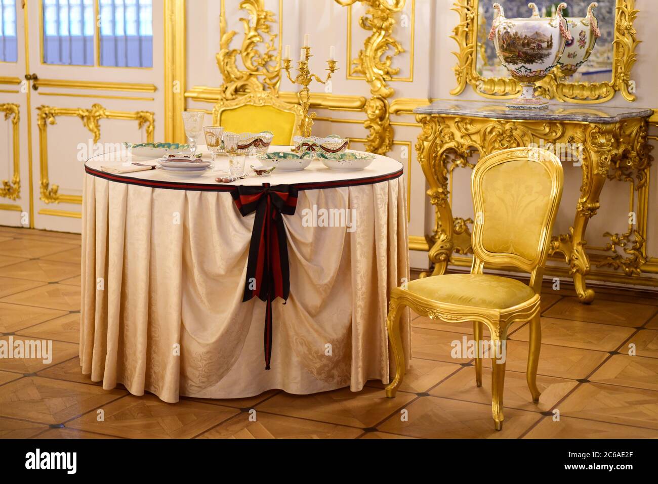 Serving dining table in a golden royal interior Stock Photo Alamy