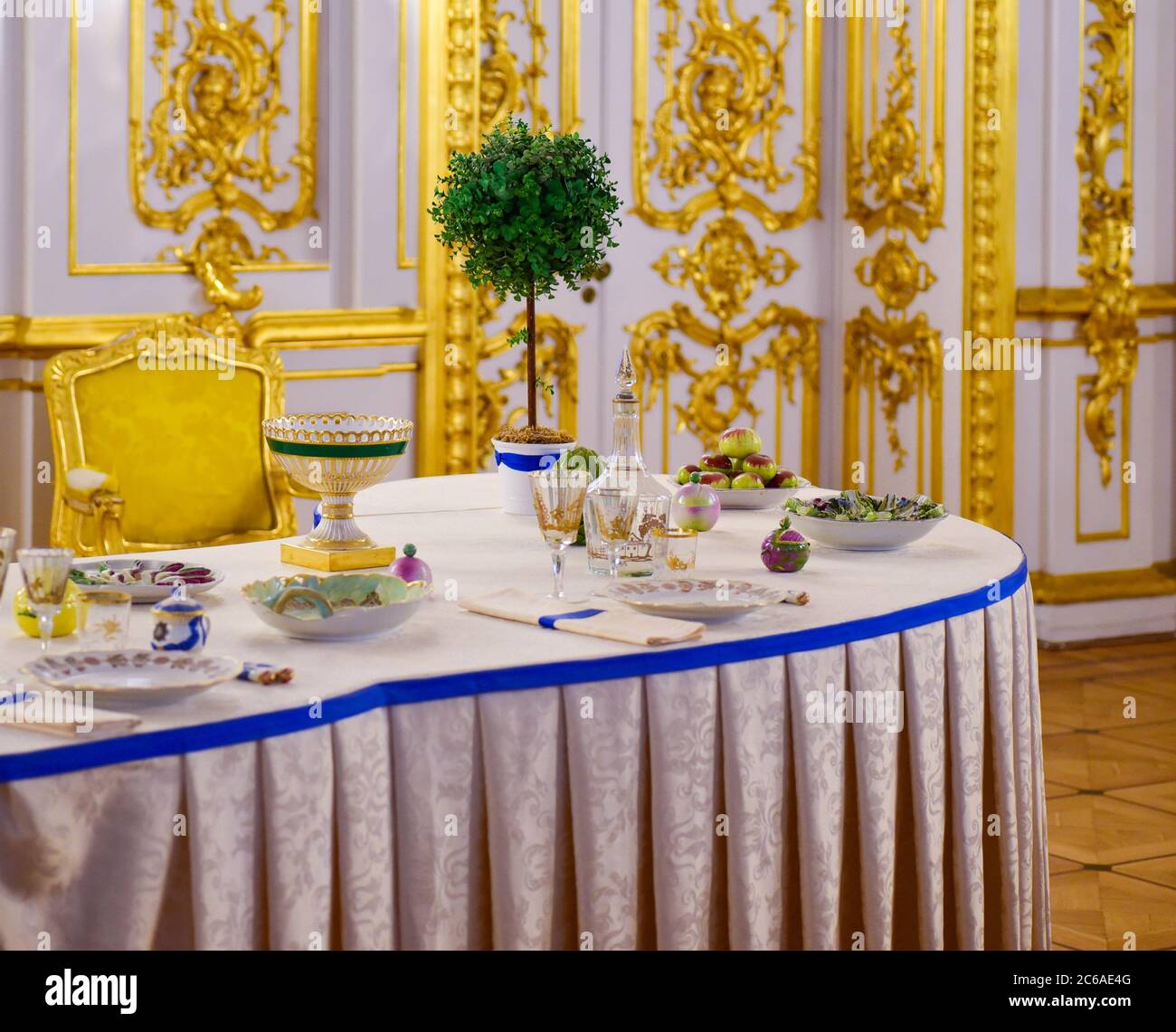 Serving dining table in a golden royal interior Stock Photo Alamy