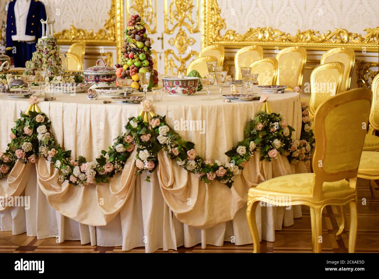 Serving dining table in a golden royal interior Stock Photo Alamy