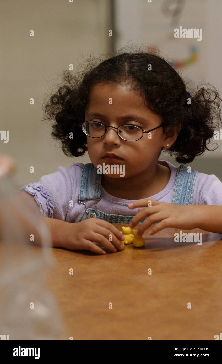 Mabank, Texas, September 2003: Girl with cerebral palsy, low vision due to abnormal brain development at birth, learning to count in pairs during life skills class at public school. MODEL RELEASE SP76. ©Bob Daemmrich Stock Photo