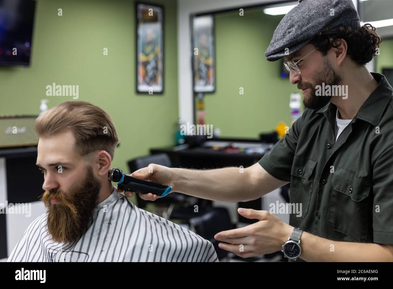 Haircut men Barbershop. Men's Hairdressers; barbers. Barber cuts the client machine for haircuts. Stock Photo