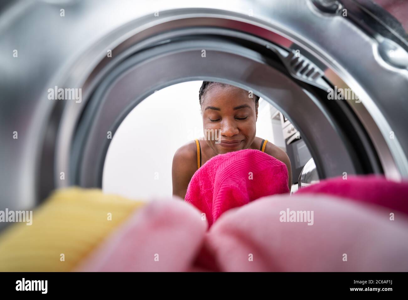 Smelling Washed Clothes Or Laundry At Home Stock Photo
