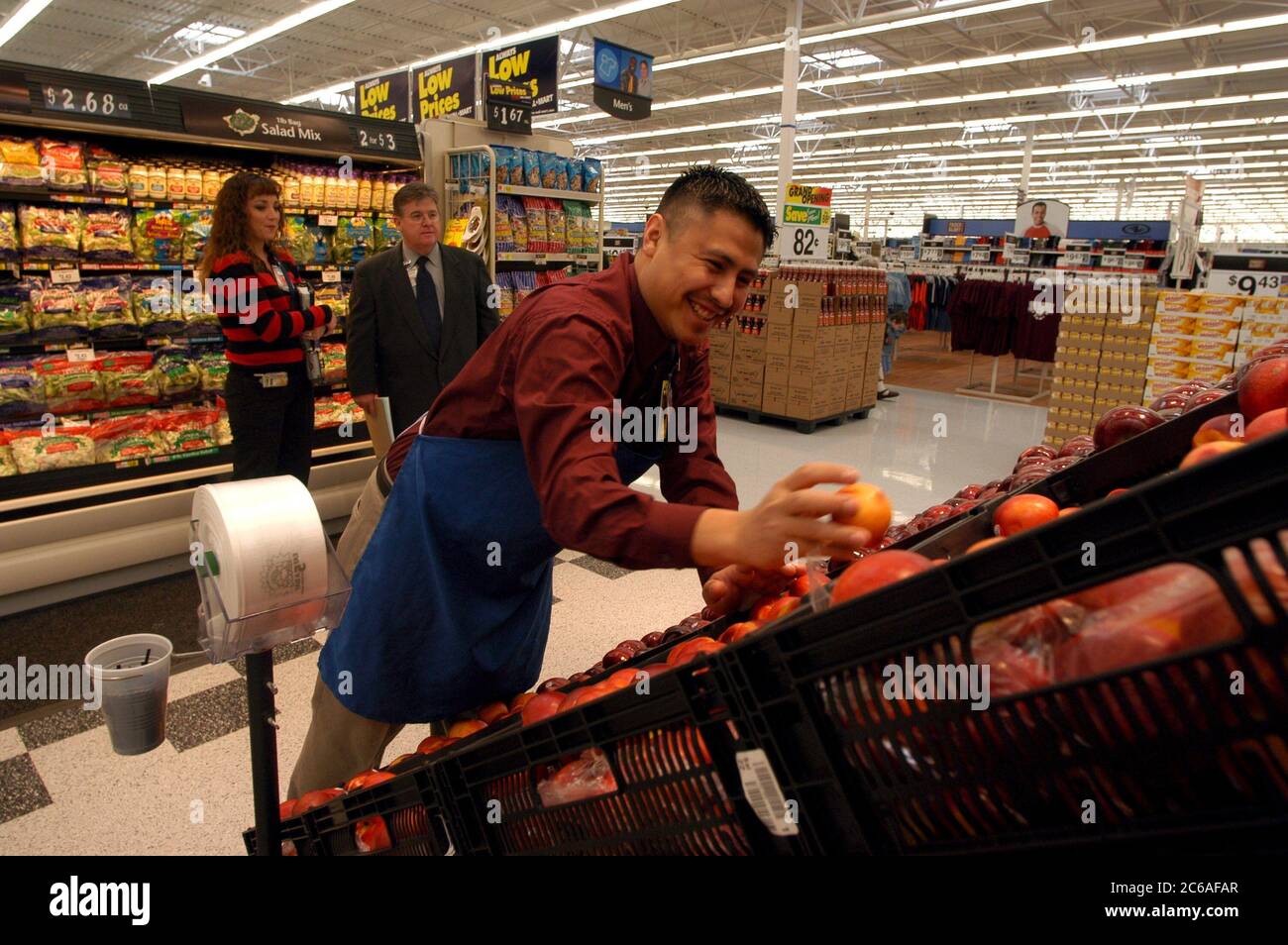 San Antonio, Texas USA, January 21, 2004 Fruit stocker stacks apples