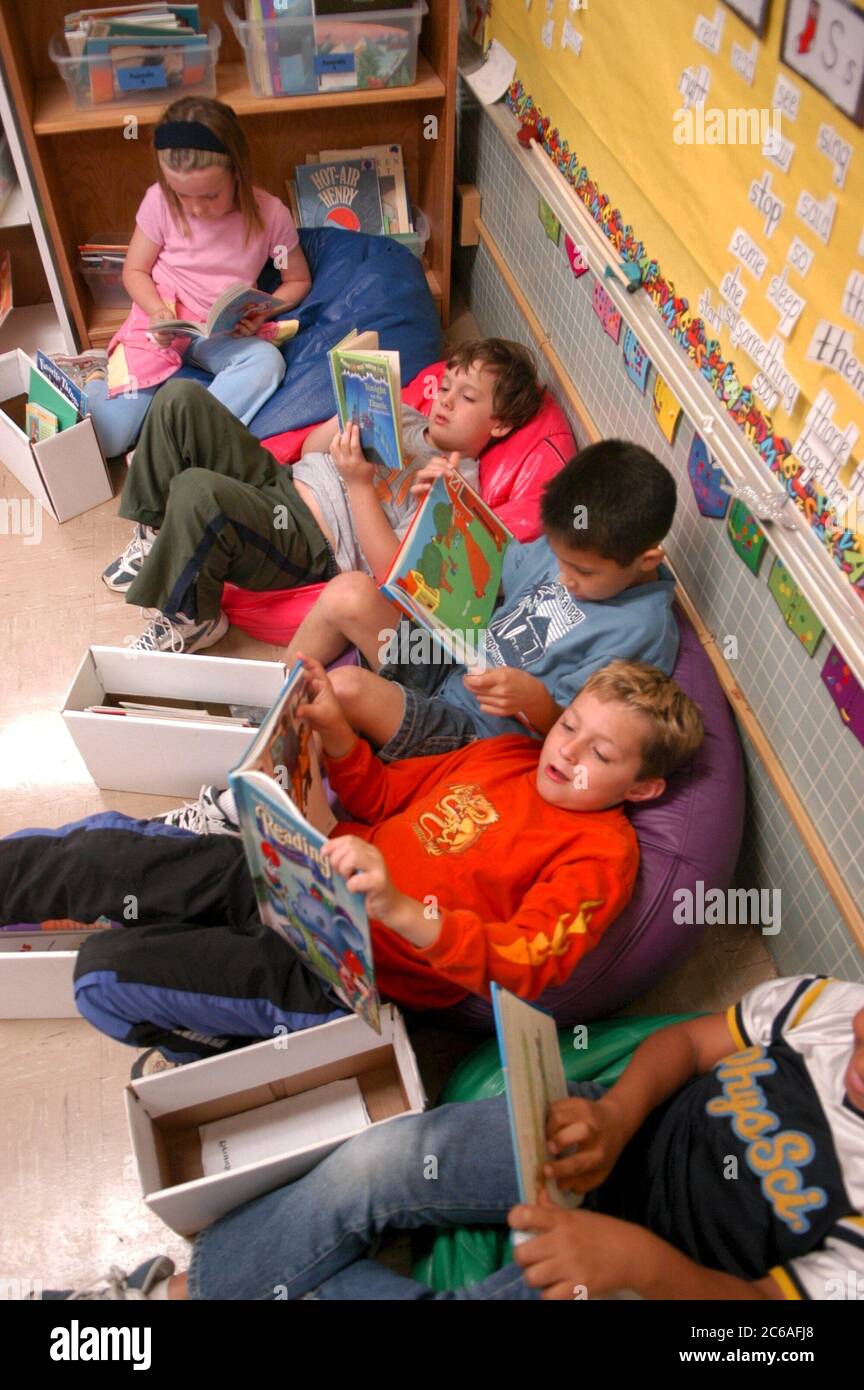 Austin Texas USA, May 2004: First grade boys and girl sit in bean bag chairs during independent reading time in their public school classroom.  ©Bob Daemmrich Stock Photo