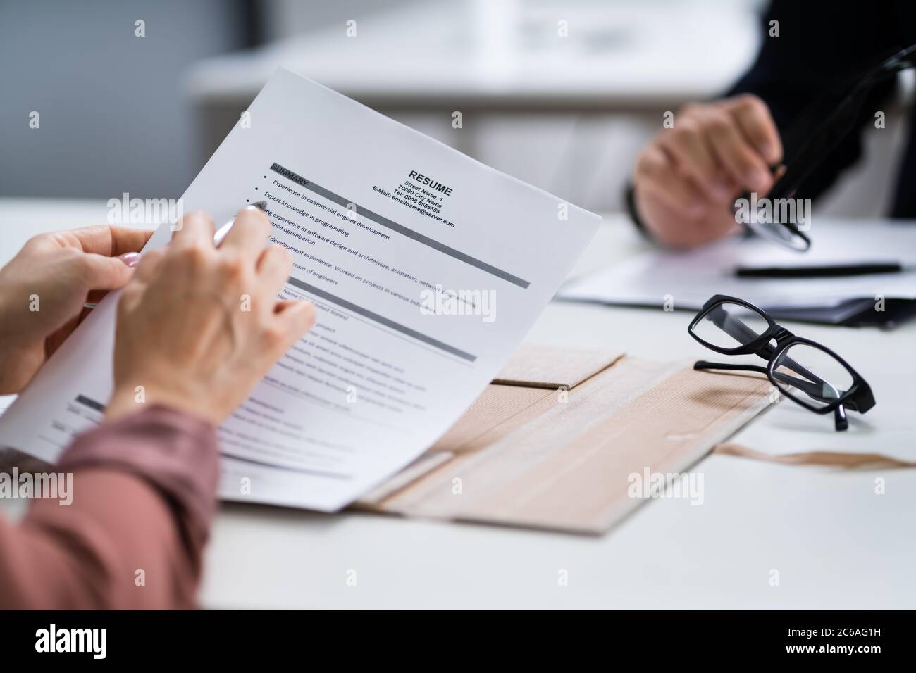 Reading Resume And Recruitment Application At Job Interview Stock Photo