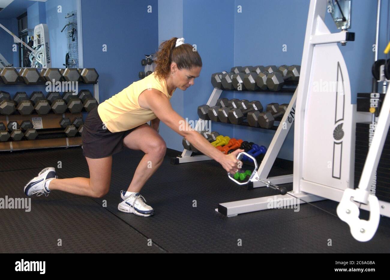 Personal trainer demonstrating a Cable One leg squat with row- This is a  compound movement of a single leg squat and adds an upperbody pull to  complete this total body combination. ©Bob