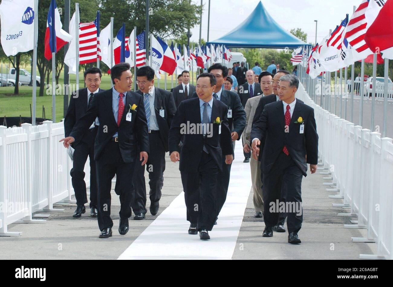 Austin Texas USA, July 23 2004: Samsung executives, including Samsung Semiconductor President Y.W. Lee (center) walk to groundbreaking ceremonies for a $500 million expansion to the company's Austin chip fabrication facility.  ©Bob Daemmrich Stock Photo