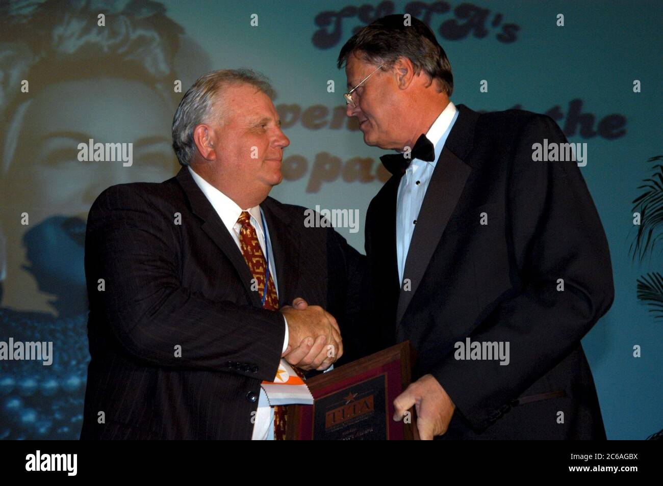 Corpus Christi Texas USA, June, 2004: White male wearing tuxedo presents award to white male during formal dinner at professional association convention.  ©Bob Daemmrich Stock Photo