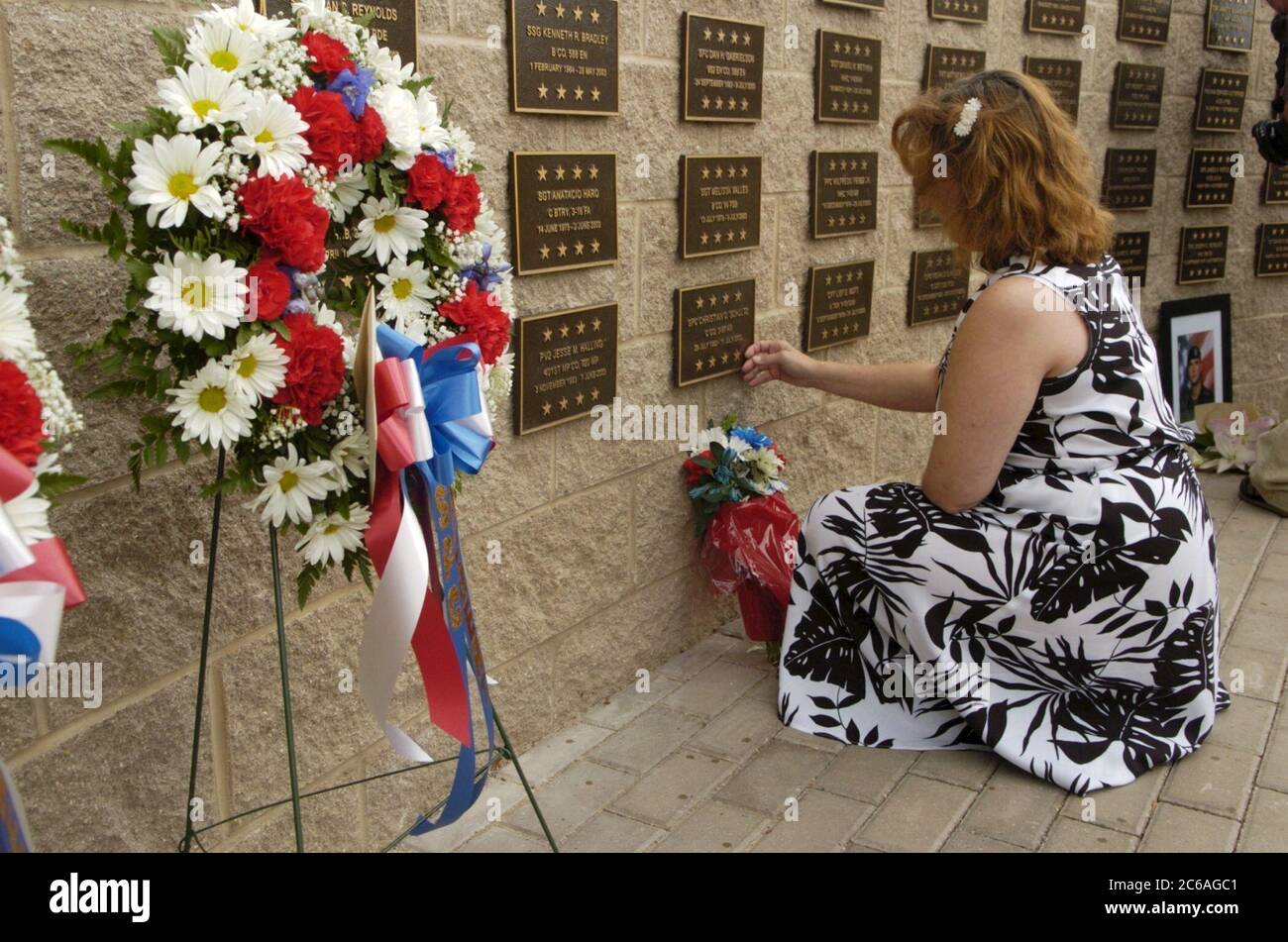 Fort Hood, Texas USA, September 2 2004: Emmy Schulz of Dallas touches the plaque commemorating her son, Christian C. Schulz, who was one of 100 soldiers from Fort Hood killed in Operation Iraqi Freedom.  ©Bob Daemmrich Stock Photo
