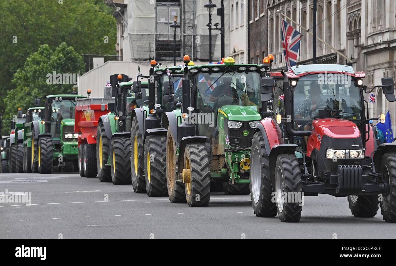 People during a demonstration organised by Save British Farming (SBF) of go-slow tractors and farming supporters in Parliament Square in Westminster, London to protest about threats to UK food standards in future trade deals. Stock Photo