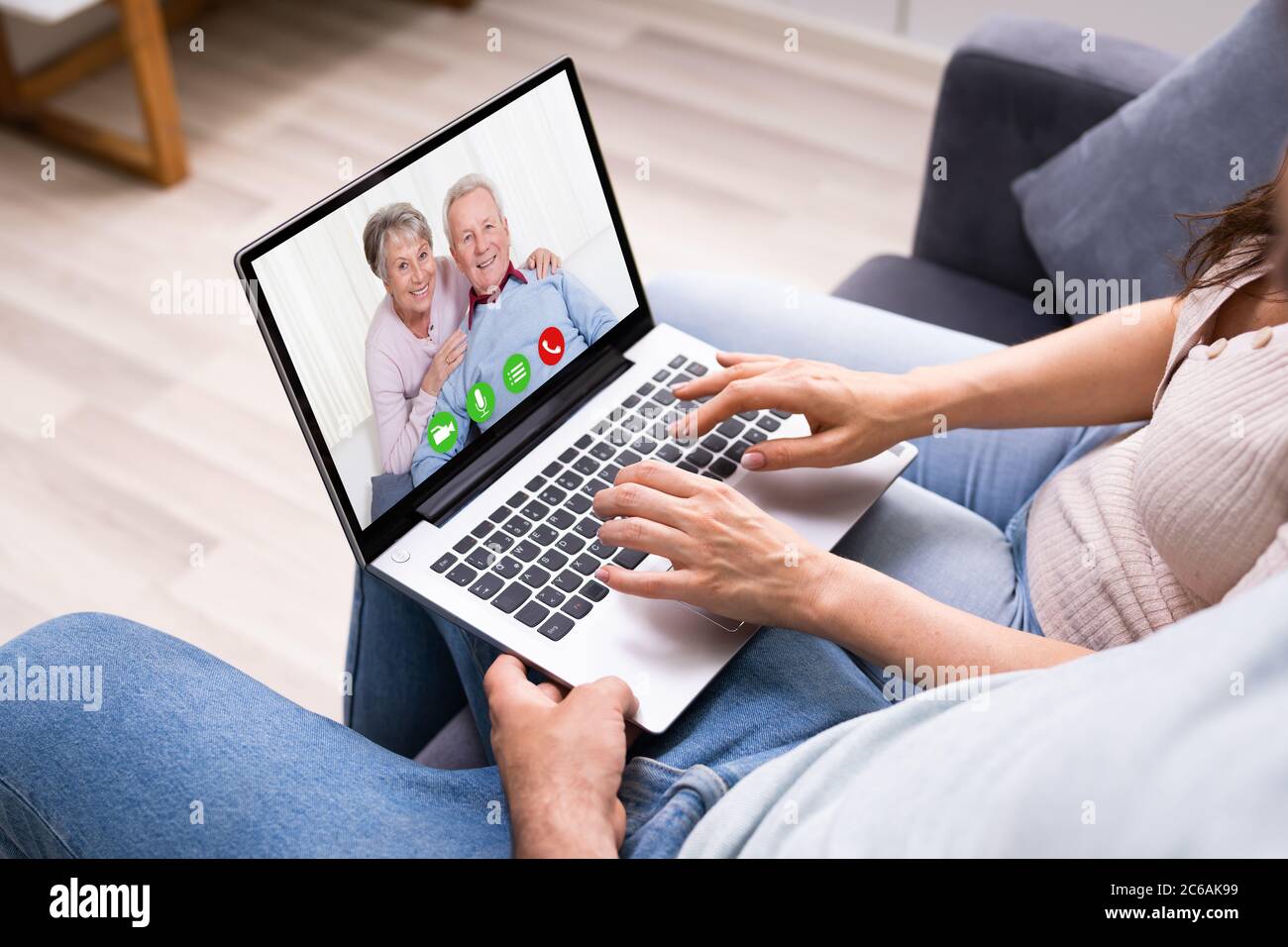 Couple In Video Conference Chat With Parents Stock Photo