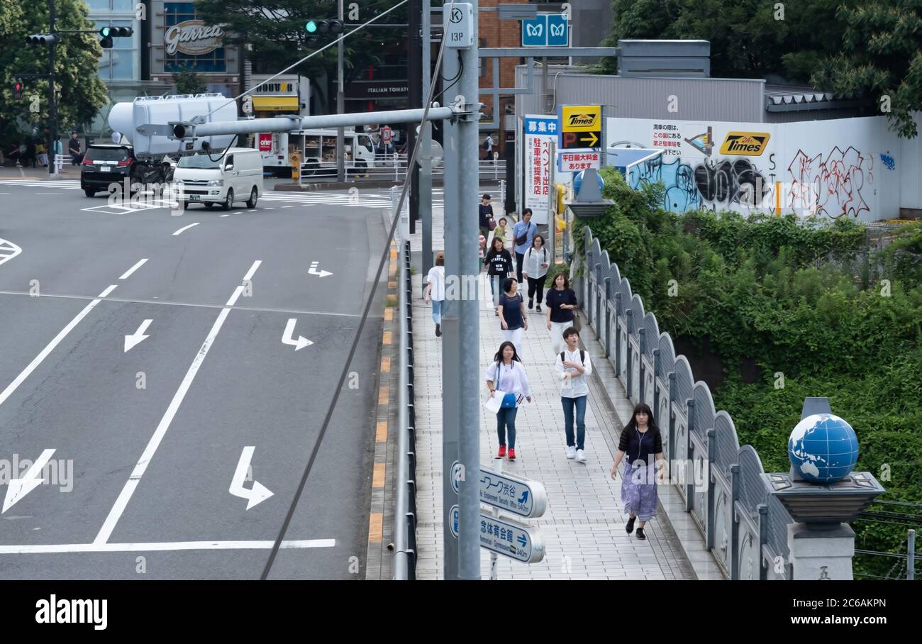 Pedestian at Harajuku's Jingu Bashi or shrine bridge, Tokyo, Japan Stock Photo