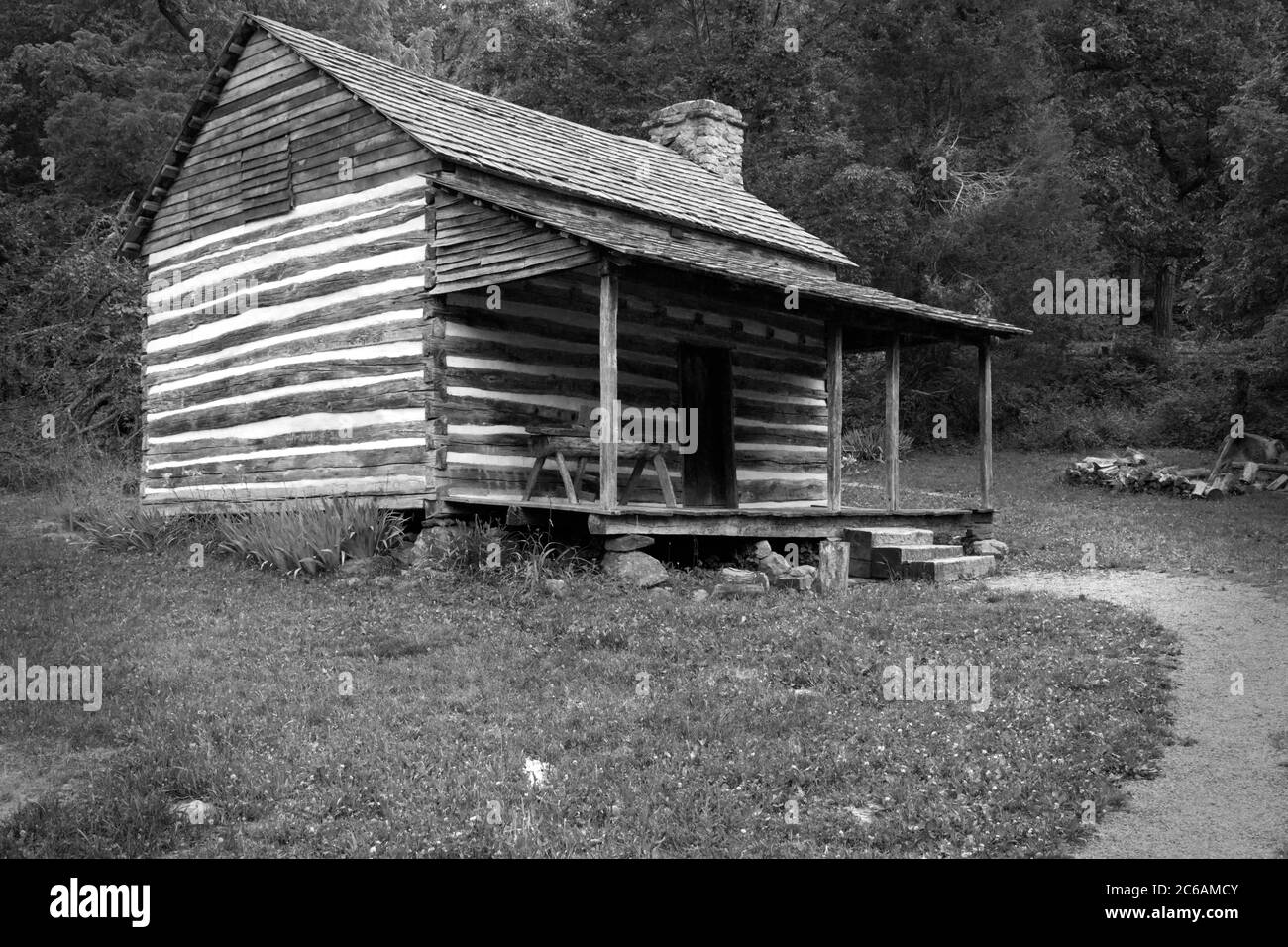 a rustic log cabin in the Appalachian mountains portrayed in black and white (monochrome Stock