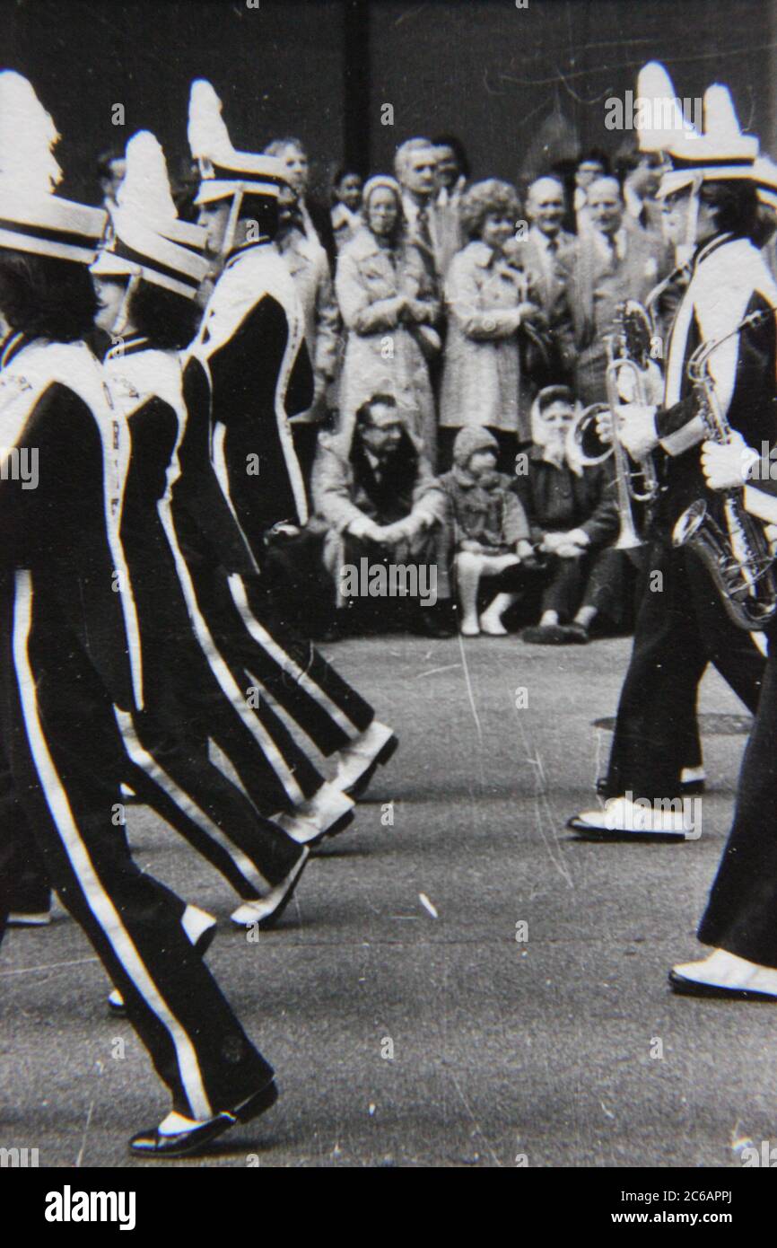 Fine 70s vintage black and white lifestyle photography of a high school marching band marching in a downtown Chicago parade. Stock Photo