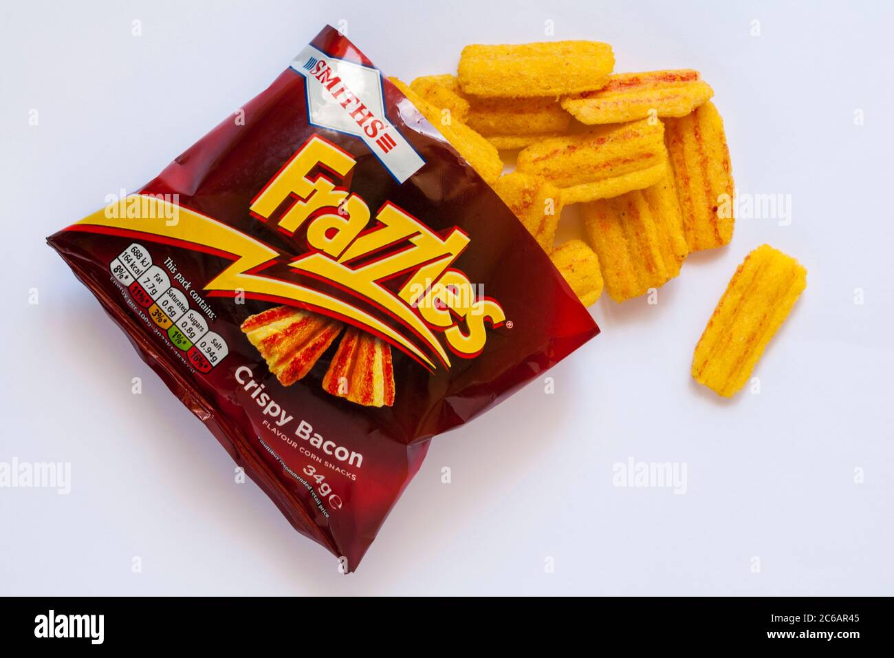 packet of Smiths Frazzles Crispy Bacon flavour corn snacks opened with contents spilled spilt isolated on white background Stock Photo