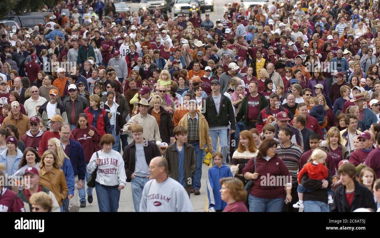 Austin, Texas USA, November 26 2004: Texas A&M University fans bring up the rear of the traditional parade up Congress Avenue, featuring the A&M Corps of Cadets and marching band, before the A&M-Texas college football game. ©Bob Daemmrich Stock Photo