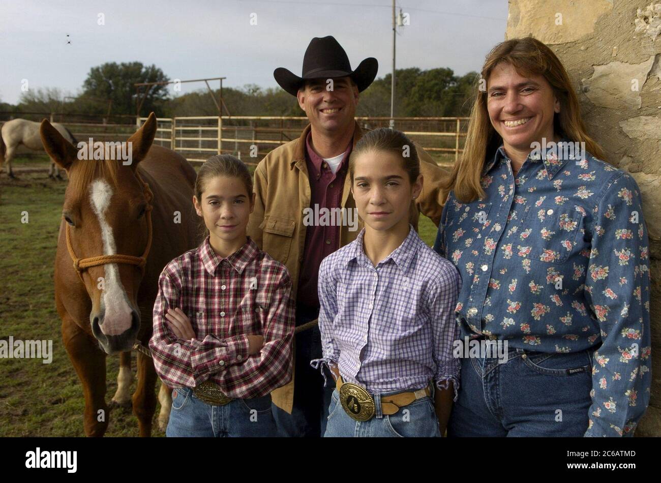 Brownwood, Texas November, 2004:  The Richard Jordan ranching family of Brooke Smith, TX in rural Brown County, TX. Family members are Richard Jordan, Marie Jordan and twin daughters Casey (in purple shirt) and Kelsey.  The Jordans are full-time cattle ranchers,  part of a shrinking number of Texas family ranchers.  MR All Model Released OK ©Bob Daemmrich Stock Photo