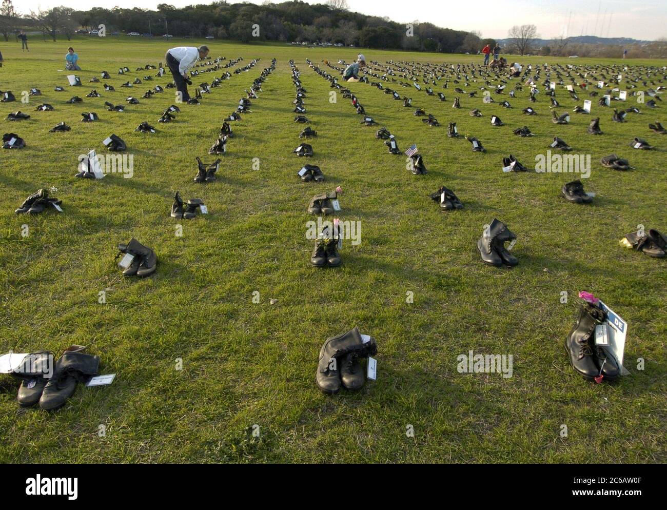 Military combat boots representing American service members killed in the conflict in Iraq dot a grassy expanse in Zilker Park in Austin Texas. The dramatic display is part of a national traveling tour, 'Eyes Wide Open: The Human Cost of War in Iraq' co-sponsored by the American Friends Service Committee. ©Bob Daemmrich Stock Photo