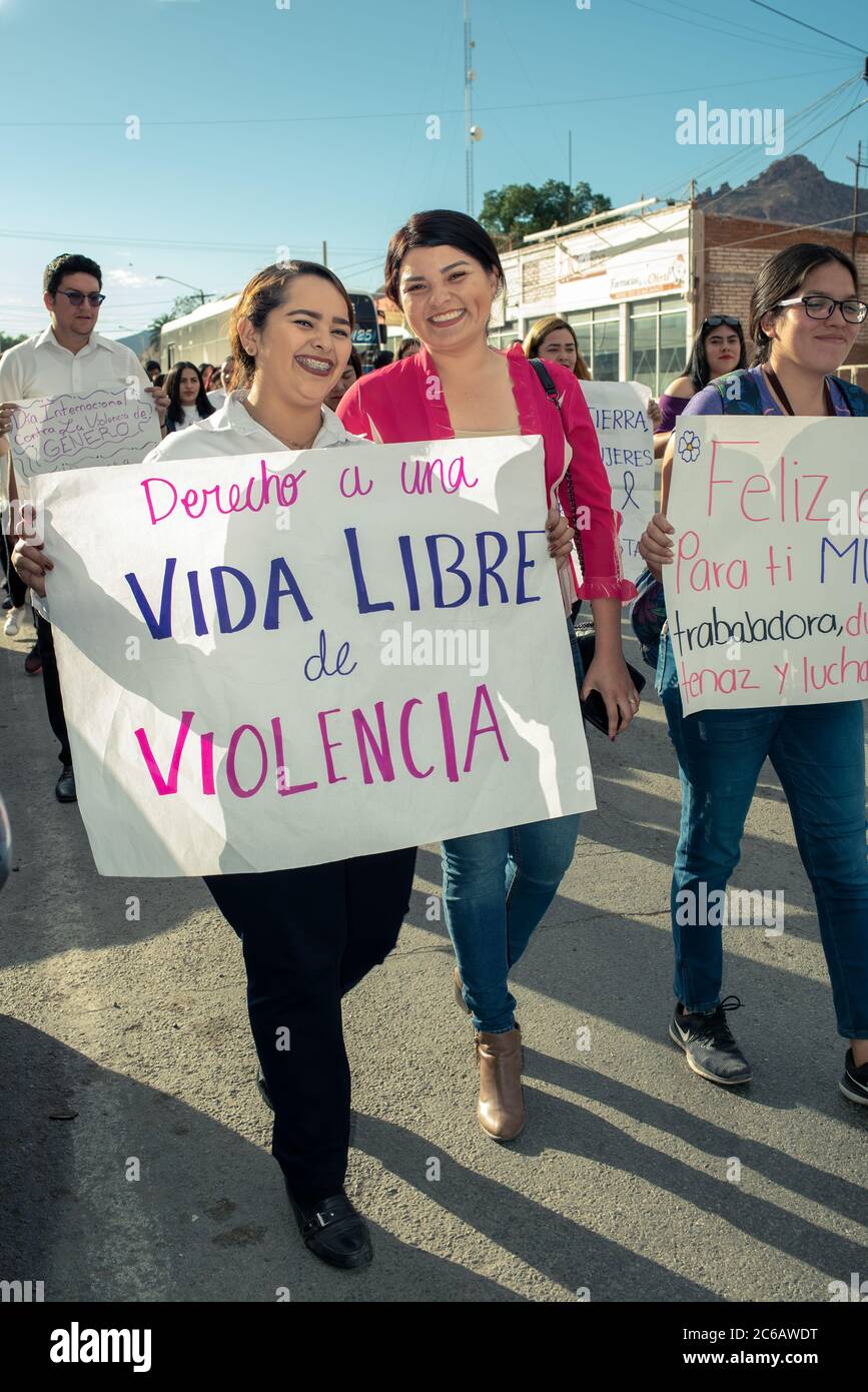 Young women in Guaymas, Sonora, Mexico, holding protest signs in an organized march to bring attention to violence against women. Stock Photo
