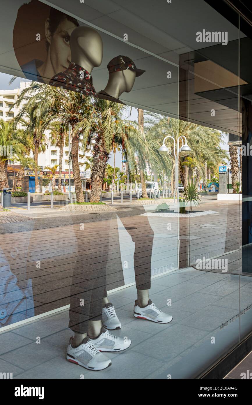 Reflections and mannequins in a shop window display, shut in the aftermath of covid 19 lockdown Playa de Las Americas, Tenerife, Canary Islands, Spain Stock Photo
