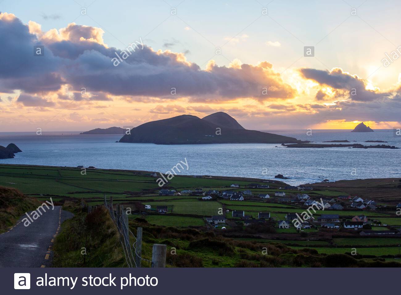 A view of the Irish-speaking village of Dunquin and the Great Blasket Island on a wonderful evening along the Wild Atlantic Way as the sun goes down. Stock Photo